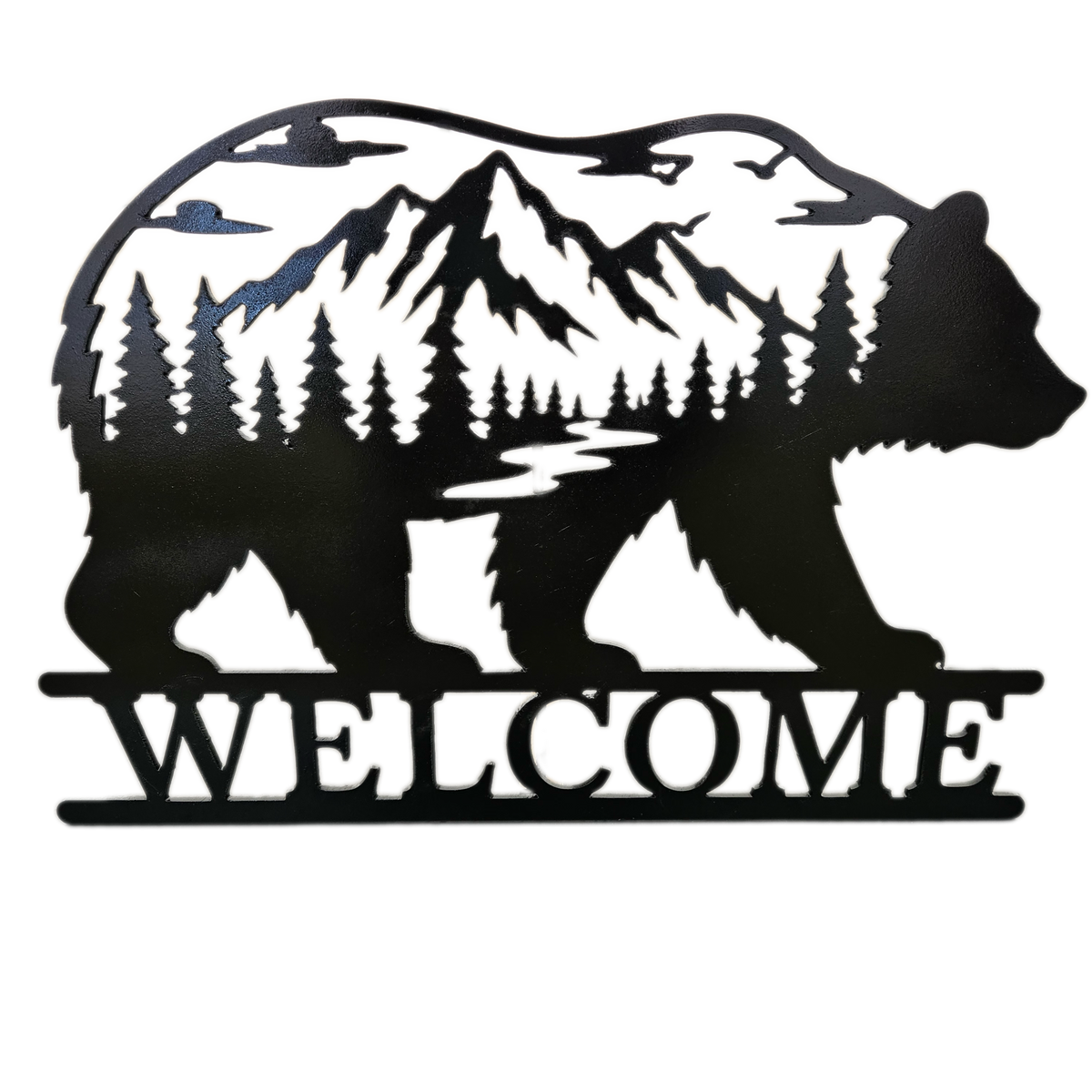 Black metal wall art featuring a bear silhouette filled with a mountain, pine tree forest, and river scene, with the word WELCOME cut across the bottom, shown on a plain white background.